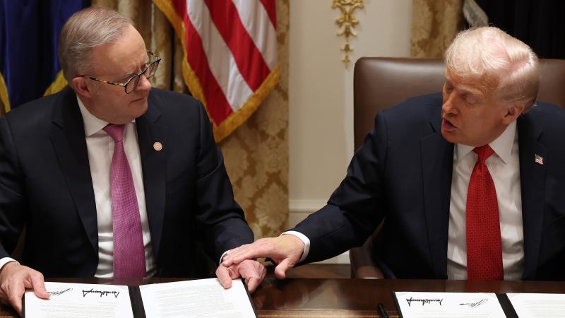 Prime Minister of Australia Anthony Albanese (L) and U.S. President Donald Trump sign a $8.5 billion rare earth minerals agreement during a bilateral meeting in the Cabinet Room of the White House on October 20, 2025 in Washington, DC