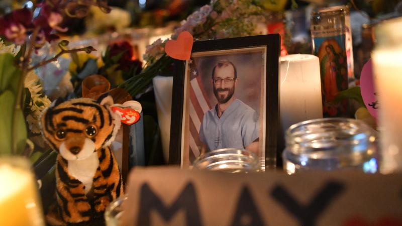 Photo of Alex Pretti is displayed at a makeshift memorial in his honor in the area where he was shot dead by federal immigration agents in Minneapolis