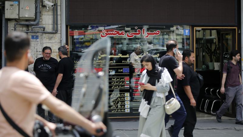 TEHRAN, IRAN - MAY 4: Citizens of Iran are seen as the US dollar hits an all-time high on the open market as the national currency continues to depreciate sharply under the impact of heavy US sanctions and war-driven economic pressures, driving up prices of essential goods and affecting commercial activity across the country, on May 4, 2026, in Tehran, Iran. (Photo by Fatemeh Bahrami/Anadolu via Getty Images)