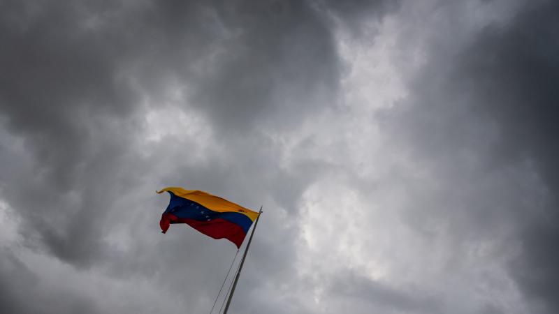  The Venezuela Flag Against A Grey Sky - stock photo