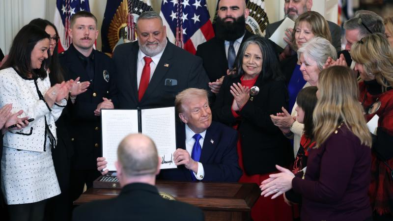 U.S. President Donald Trump holds up a proclamation dedicating February 22nd as Angel Family Day during a remembrance ceremony held in the East Room at the White House February 23, 2026 in Washington, DC. The term “Angel Families” is used to describe people who have lost a relative to a crime committed by an undocumented immigrant. 
