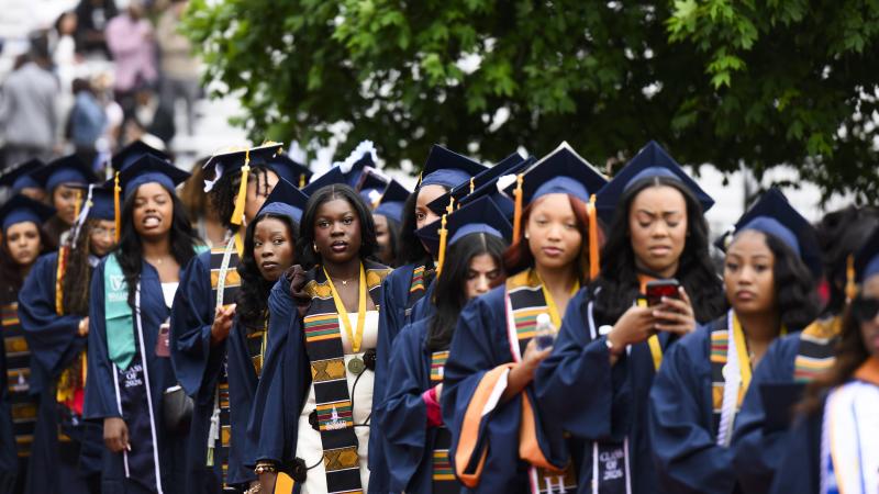 Students walk in during Howard University's 158th Commencement Convocation in Washington, D.C.