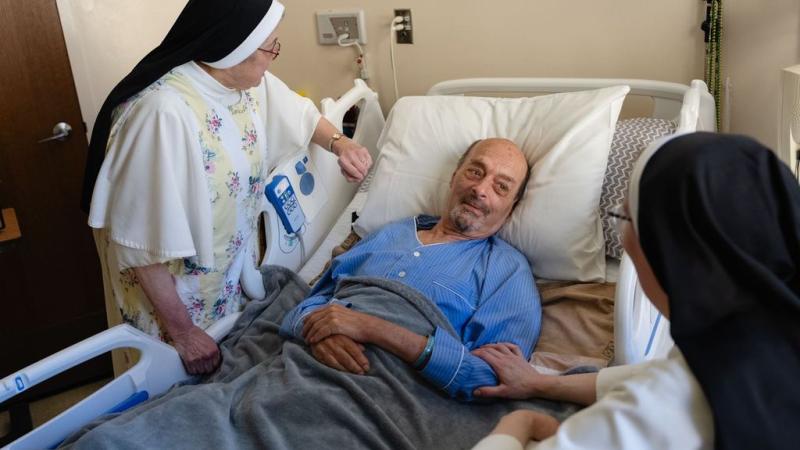 Carmelite Sisters for the Aged and Infirm visit a patient