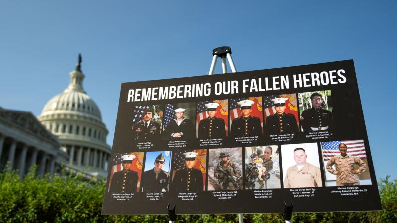  sign displaying photos and names of the 13 service members killed in a terrorist attack at Abbey Gate outside Kabul's Hamid Karzai International Airport is seen during a news conference at the U.S. Capitol on September 9, 2024 in Washington, DC. 