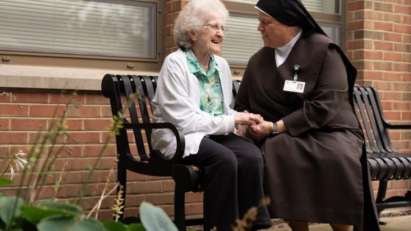 Catholic nun with elderly woman