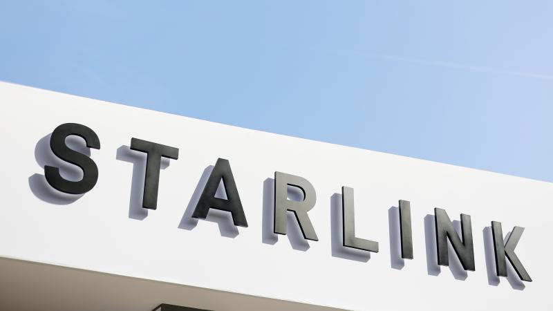 The Starlink corporate logo, part of the SpaceX ecosystem, is seen against a clear blue sky at the Fira Gran Via in Barcelona, Spain, on March 5, 2026.