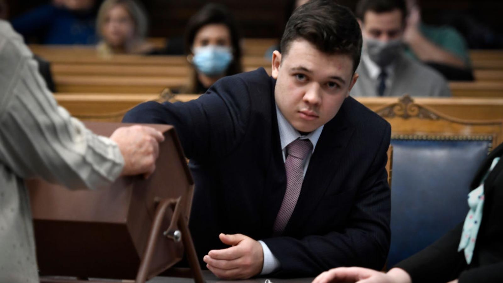 Kyle Rittenhouse pulls numbers of jurors out of a tumbler during his trial at the Kenosha County Courthouse