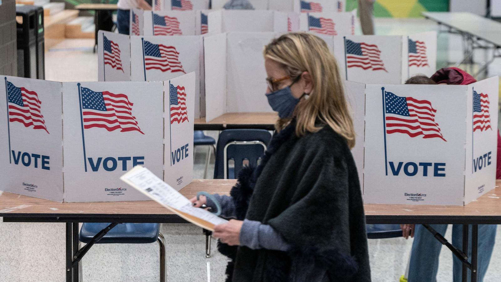 A woman waits to cast her ballot at George Marshall High School, being used as a polling location, on election day in Falls Church, Virginia on November 2, 2021.