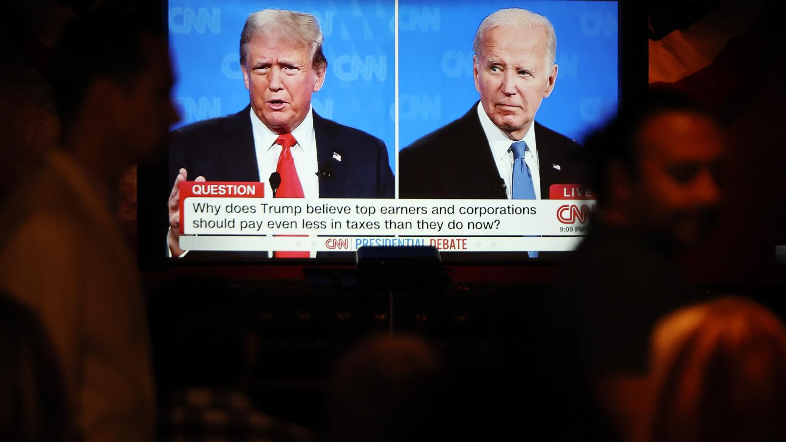 People watch the CNN presidential debate between U.S. President Joe Biden and Republican presidential candidate former President Donald Trump at a debate watch party at The Continental Club on June 27, 2024 in Los Angeles, California.