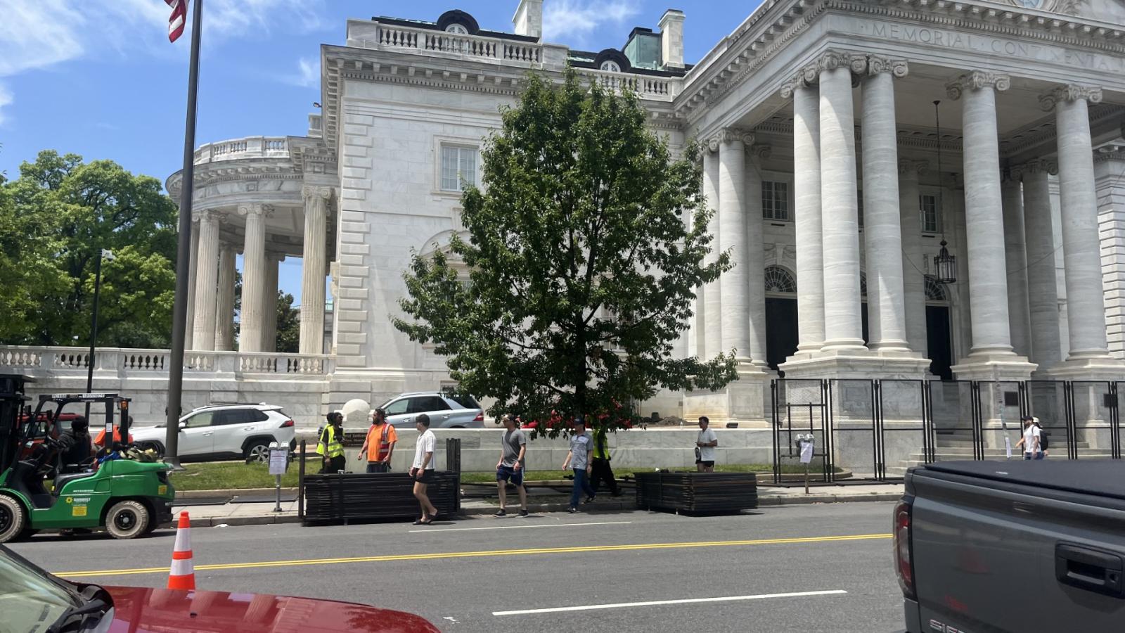 Workers assemble fences for the Army's 250 birthday celebration